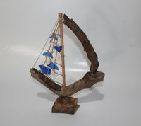 Driftwood Boat with Blue Sail